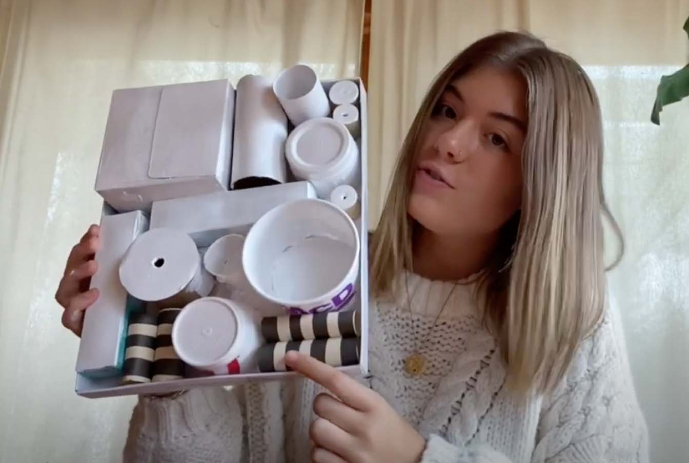 Student with recycled materials art